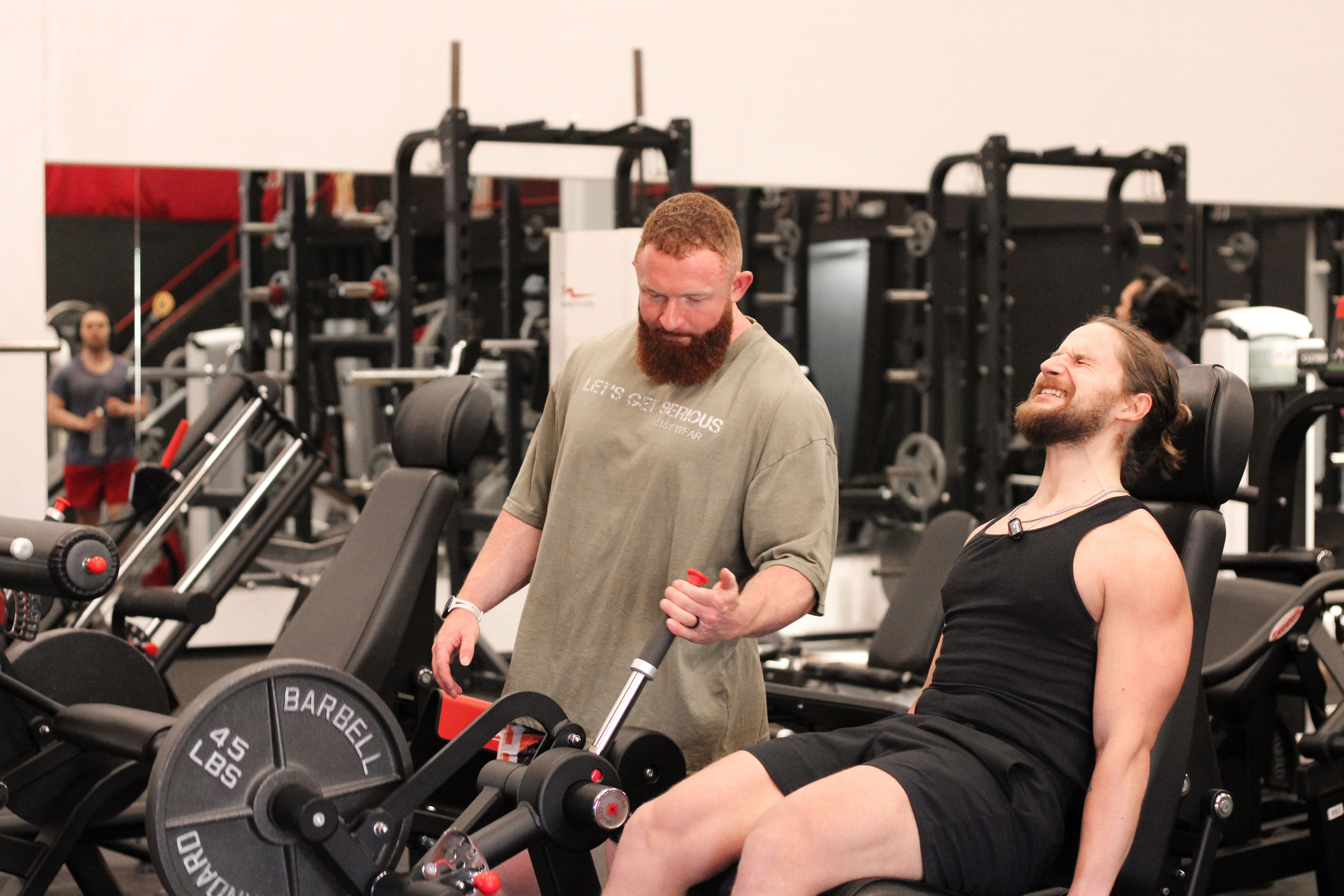 Personal Trainer Marlin Foy guides a client through a leg workout at Iron Forge Gym in Austin, TX