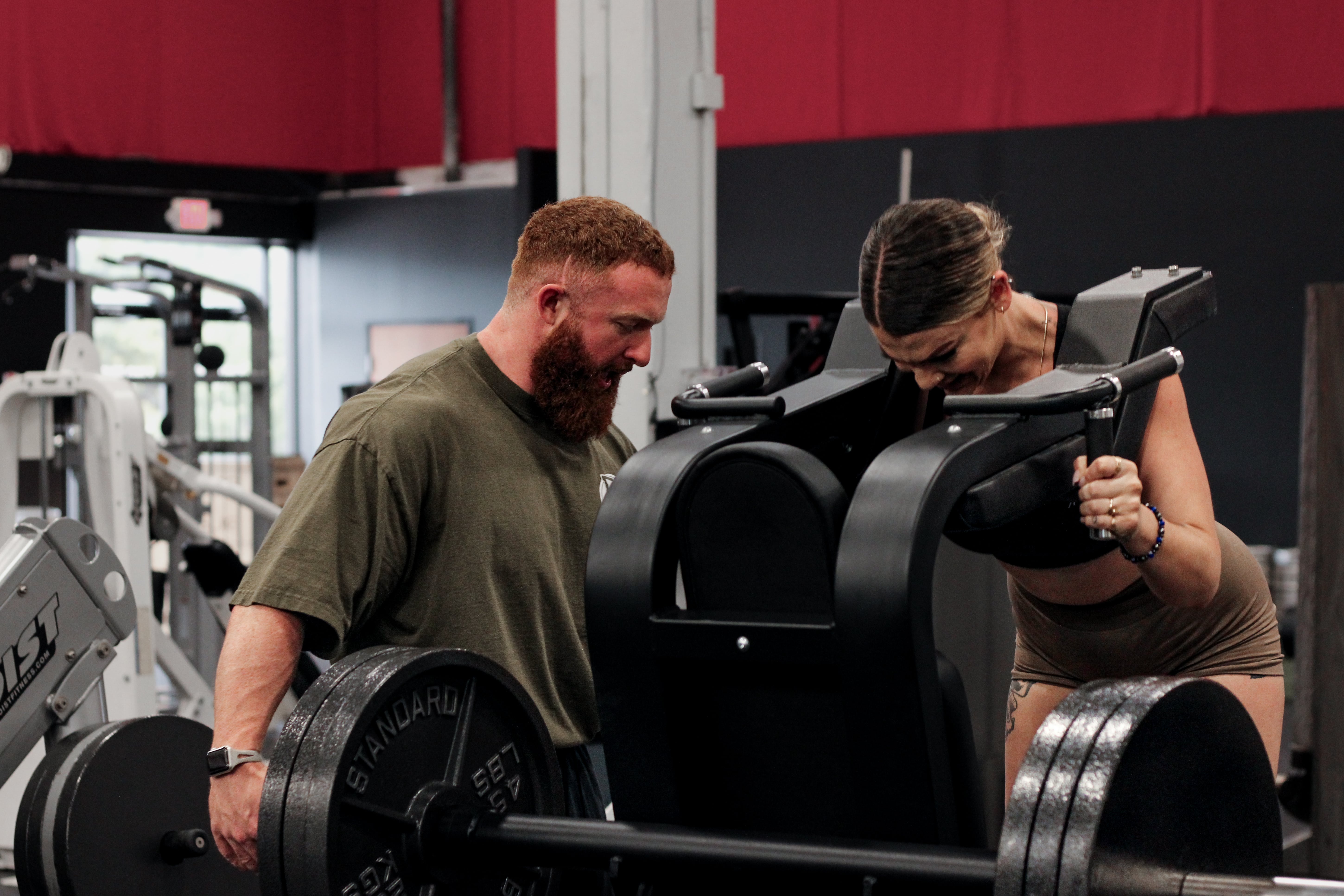 Personal Trainer Marlin Foy guides a client through a leg workout at Iron Forge Gym in Austin, TX